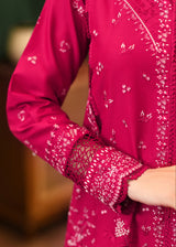 Close-up of a pink embroidered garment with intricate patterns.