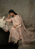 Woman in traditional embroidered outfit sitting next to a white horse in a rustic setting