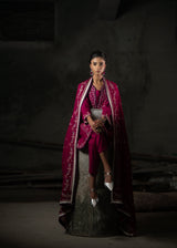Woman in a traditional outfit with a dark background